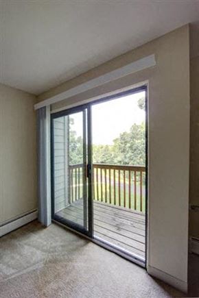 Round Lake apartment for rent - a living room with a balcony and a sliding glass door