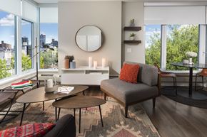 Calgary apartment for rent - Livingroom with a chair, area rug, coffee table, and mirror