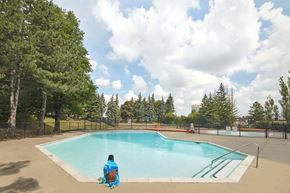 Brampton apartment for rent - a person sitting in front of a swimming pool