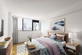 Brampton apartment for rent - a bedroom with a bed and a large window