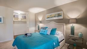Randallstown apartment for rent - a bedroom with a bed with blue pillows on it