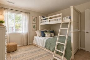 Dundalk apartment for rent - A bedroom with a bunk bed and a window with curtains.