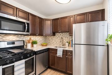Dundalk apartment for rent - A kitchen with brown cabinets and stainless steel appliances.