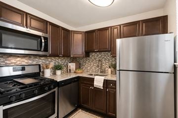 Dundalk apartment for rent - A modern kitchen with dark brown cabinets and stainless steel appliances.