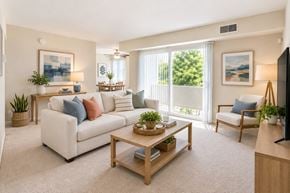 Dundalk apartment for rent - A living room with a white couch, a wooden coffee table, and a flat-screen TV.