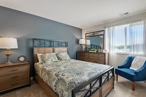 Dundalk apartment for rent - a bedroom with a bed and a chair and a window