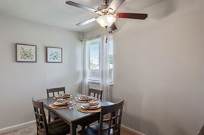 Dundalk apartment for rent - a dining room with a table and chairs and a ceiling fan