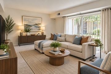 Gwynn Oak apartment for rent - A living room with a white couch, a coffee table, and a painting on the wall.
