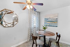 Gwynn Oak apartment for rent - a dining room with a table and chairs and a ceiling fan