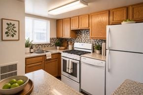 Temple Hills apartment for rent - A kitchen with a white refrigerator, white oven, and white stove top.