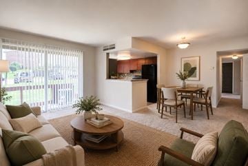 Temple Hills apartment for rent - A living room with a white couch and a coffee table.