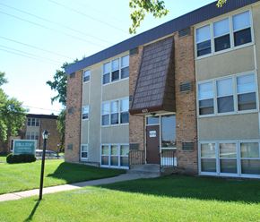 Mankato apartment for rent - the front of a brick building with a green lawn