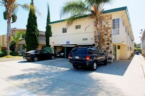 Los Angeles apartment for rent - a building with two cars parked in front of it