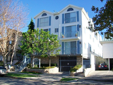 Los Angeles apartment for rent - A white and blue two story apartment building with a black gate in front.