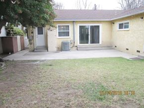 Los Angeles apartment for rent - A house with a white door and a window with bars on it.