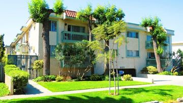Los Angeles apartment for rent - an apartment building with palm trees in front of it
