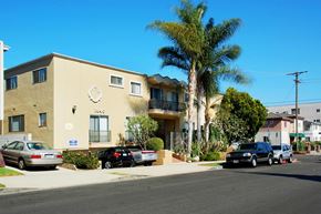 Los Angeles apartment for rent - A building with a clock on the front and cars parked in front.