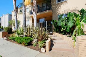 Los Angeles apartment for rent - A building with a balcony and a small garden in front.