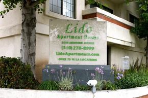 Los Angeles apartment for rent - a sign in front of a building with flowers