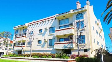 Los Angeles apartment for rent - a large white apartment building with balconies on a sunny day