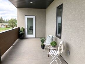 Brandon apartment for rent - a balcony with a table and two chairs and a door
