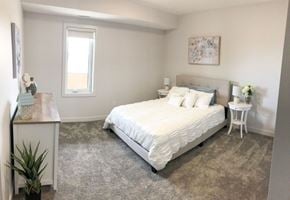 Brandon apartment for rent - a bedroom with a bed and a desk and a window