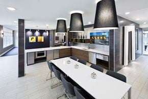 Pittsburgh apartment for rent - A modern kitchen with a white table and black chairs.