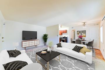 Washington apartment for rent - A living room with a white couch and a black coffee table.