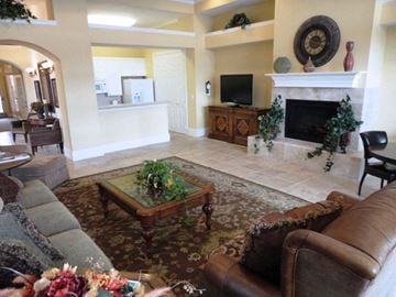 Killeen apartment for rent - A living room with a brown leather couch and a glass coffee table.