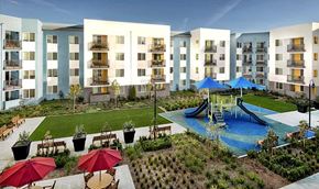 San Jose apartment for rent - A large building with a pool and slide in the courtyard.