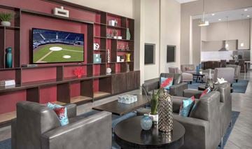 San Jose apartment for rent - A modern living room with a television displaying a baseball game.