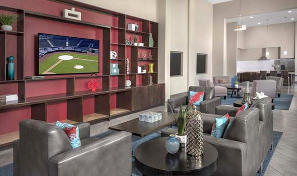 San Jose apartment for rent - A modern living room with a television displaying a baseball game.