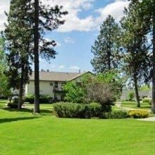 Coeur Dalene apartment for rent - A house with a white roof and a green lawn in front.