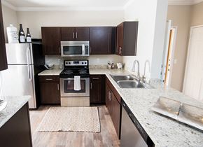 Rocklin apartment for rent - A kitchen with a stove top oven and a microwave.