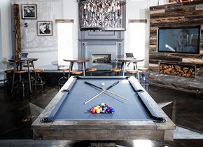 Rocklin apartment for rent - A pool table in a room with a fireplace and a television.
