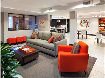 San Diego apartment for rent - a living room with orange chairs and a gray couch