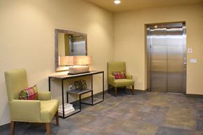 Englewood apartment for rent - Elevator area with chairs Englewood CO Senior Apartments For Rent in Englewood CO