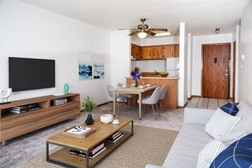 Bloomington apartment for rent - a living room with a couch and a table and a tv