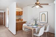 Bloomington apartment for rent - a dining room with a table and chairs and a ceiling fan