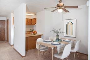 Bloomington apartment for rent - a dining room with a table and chairs and a ceiling fan
