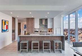 Chicago apartment for rent - a kitchen with a marble counter top and three stools