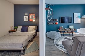 Chicago apartment for rent - a bedroom and a living room with a bed and a bike on the wall