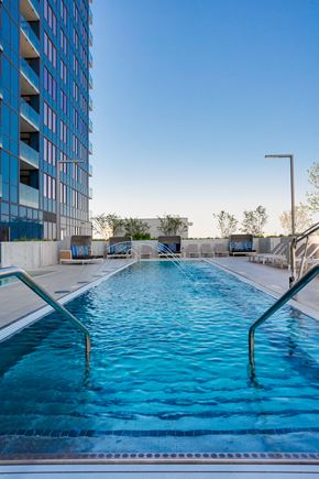 Chicago apartment for rent - a swimming pool in front of a tall building