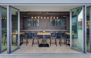 Chicago apartment for rent - a dining area with tables and chairs in a room with glass doors