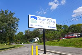 Cleveland apartment for rent - a sign for oconee village apartments on the side of a road
