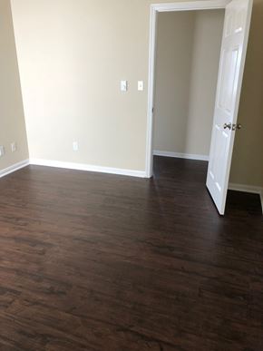 San Francisco apartment for rent - an empty living room with wood floors and a door
