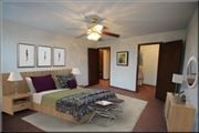 Brooklyn Center apartment for rent - a bedroom with a bed and a ceiling fan