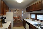Brooklyn Center apartment for rent - a kitchen with a dining room table and a refrigerator