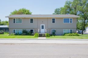 Aneta apartment for rent - A two-story house with a front porch and a garage.