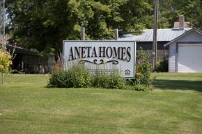 Aneta apartment for rent - A sign that says Aneta Homes in front of a house.